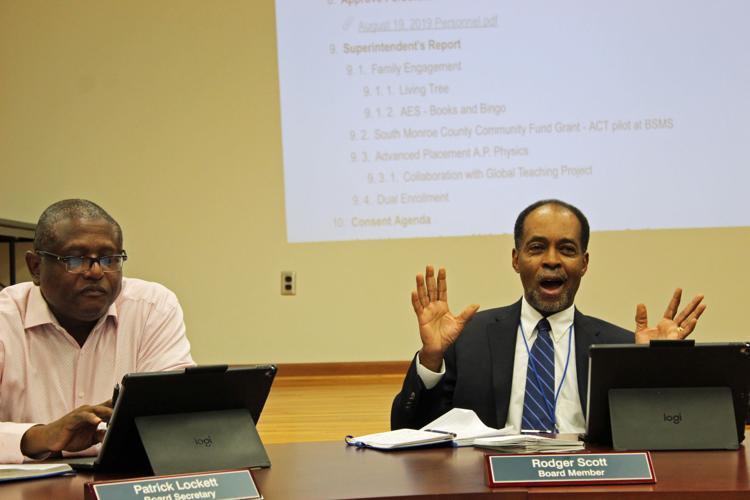 Aberdeen School Board member Rodger Scott, right, explains primitive steps being put in place at the elementary school level to prepare them for components of the ACT test. Also pictured is school board vice president Patrick Lockett.