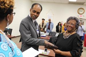 Joined with his wife, Charity, Rodger Scott takes his oath of office for his seat on the Aberdeen School Board from Sharion Gladney before last week's meeting.